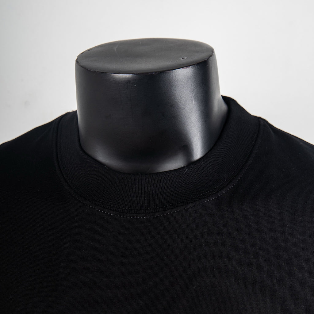 Black T-shirt neckline detail with ribbed crew neck collar