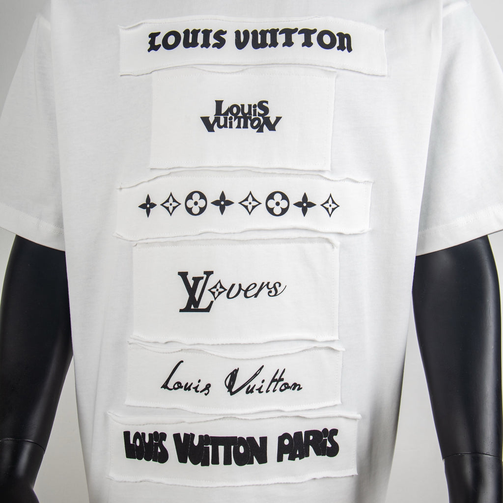 White T-shirt front with layered black logo graphics and star-flower motifs