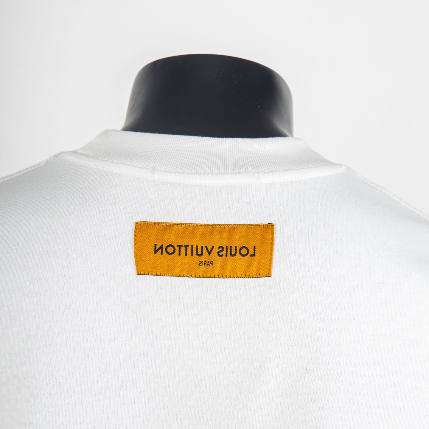 White T-shirt back neck with orange brand label tag