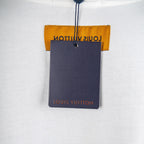 White T-shirt with attached navy hang tag and orange brand label