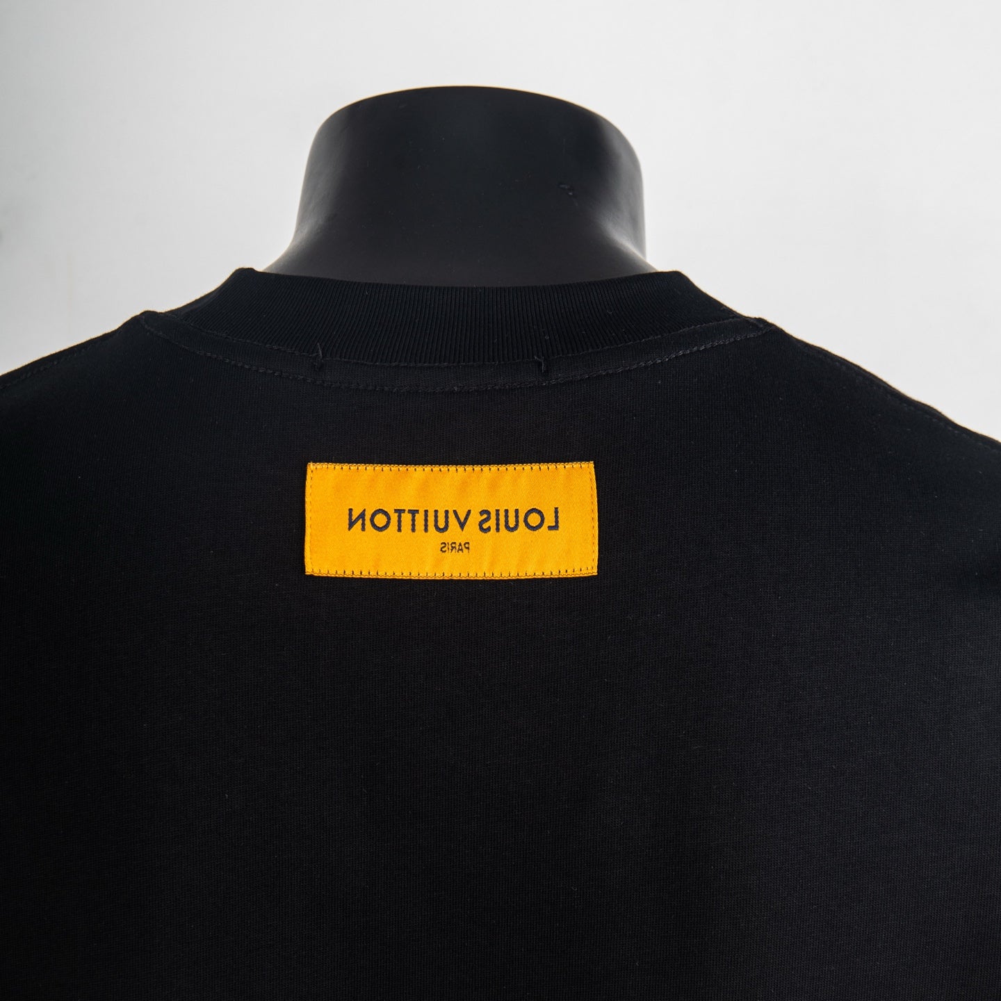 Black T-shirt back neck with yellow Louis Vuitton label