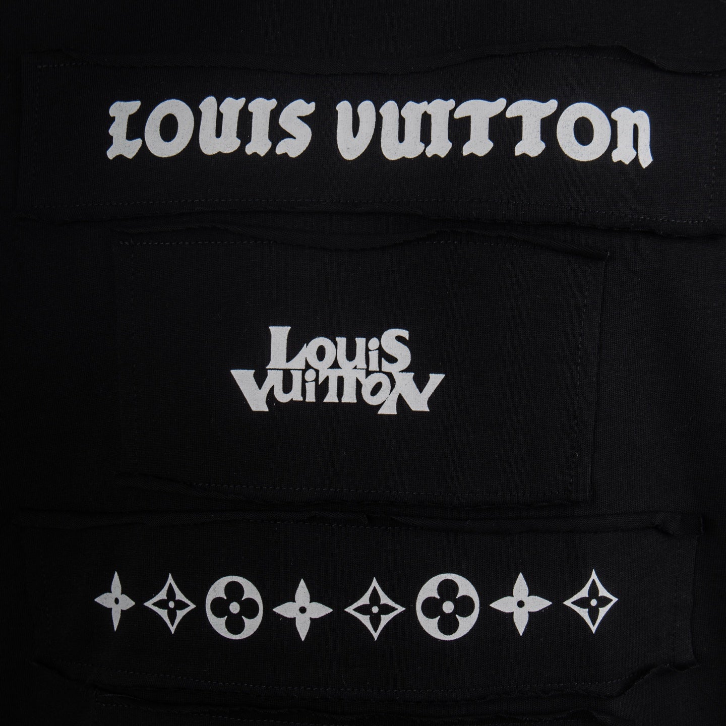 Black T-shirt close-up of Louis Vuitton front text and logo emblem row