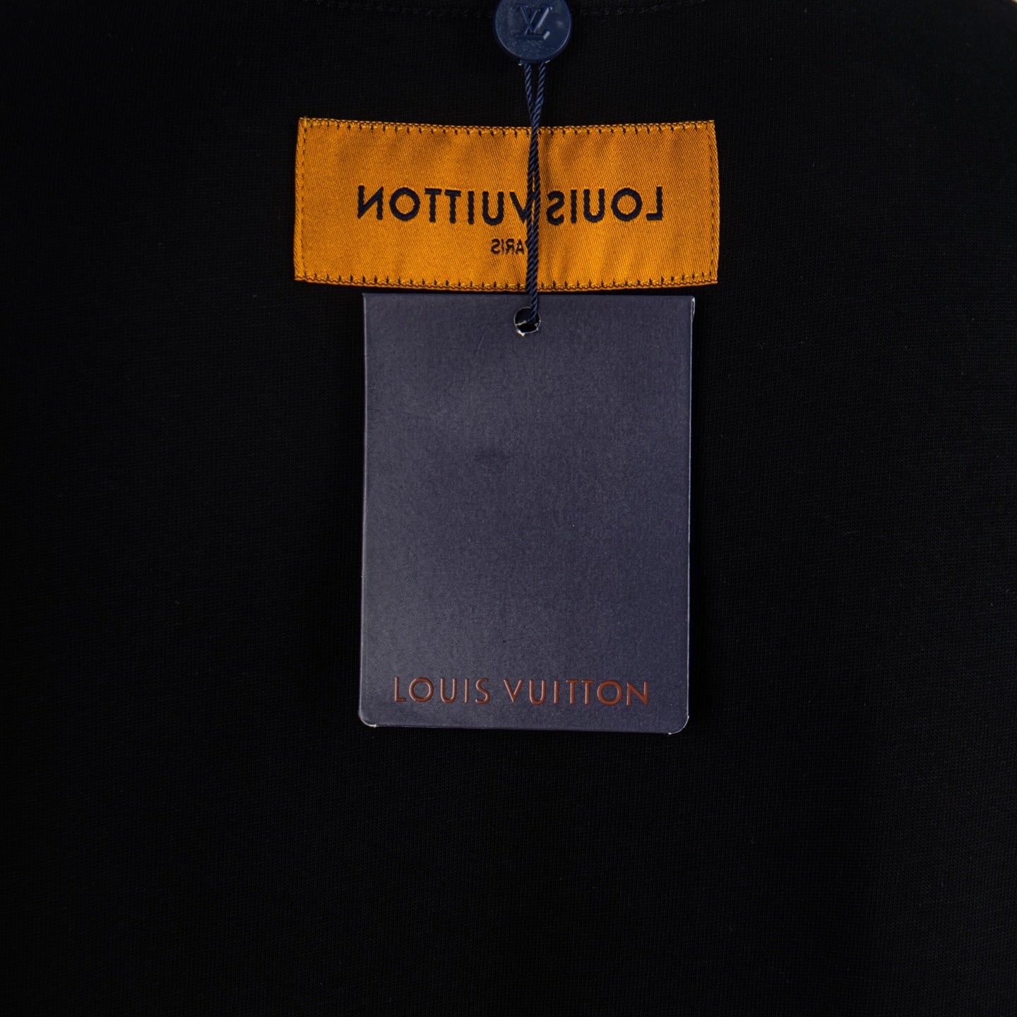 Black T-shirt hang tag with yellow Louis Vuitton label and gray card