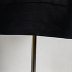 Black T-shirt hem close-up with stitched edge