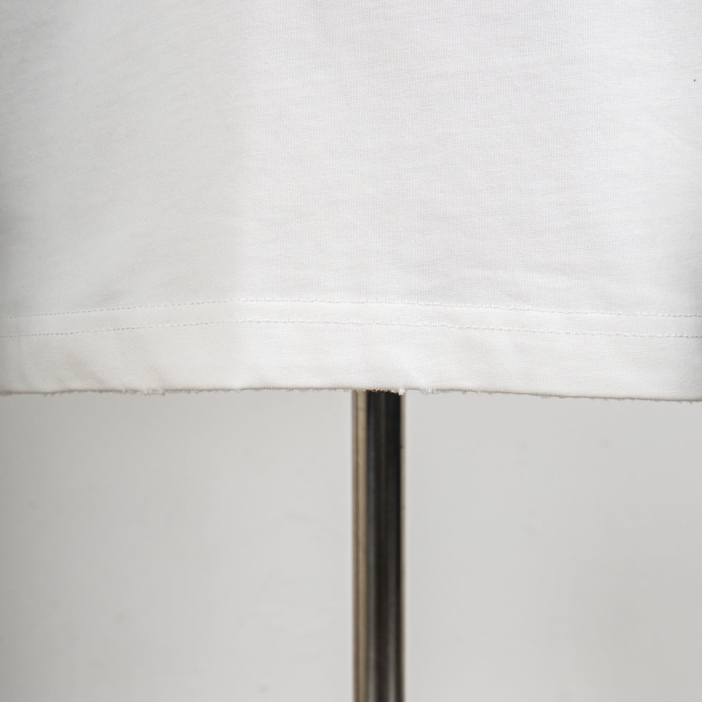 White T-shirt hem with neat stitched edge