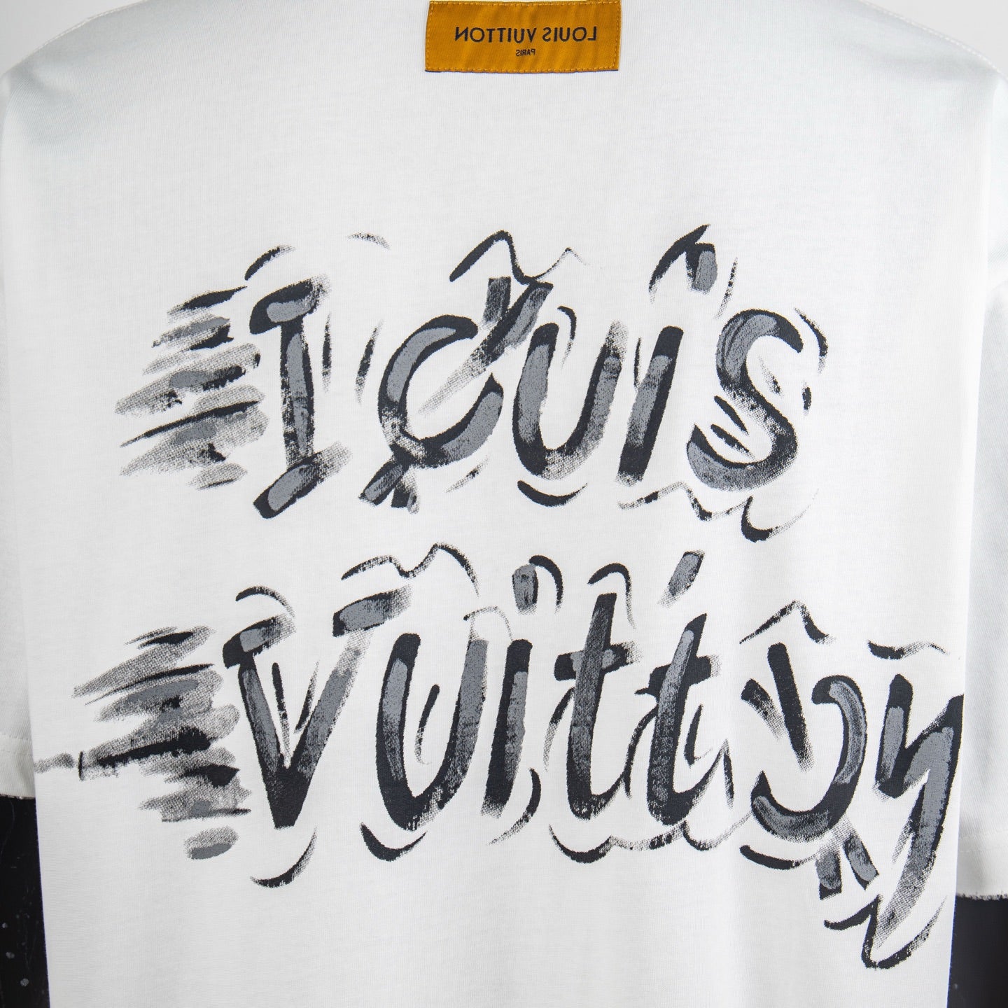 White T-shirt close-up of large back graphic script logo