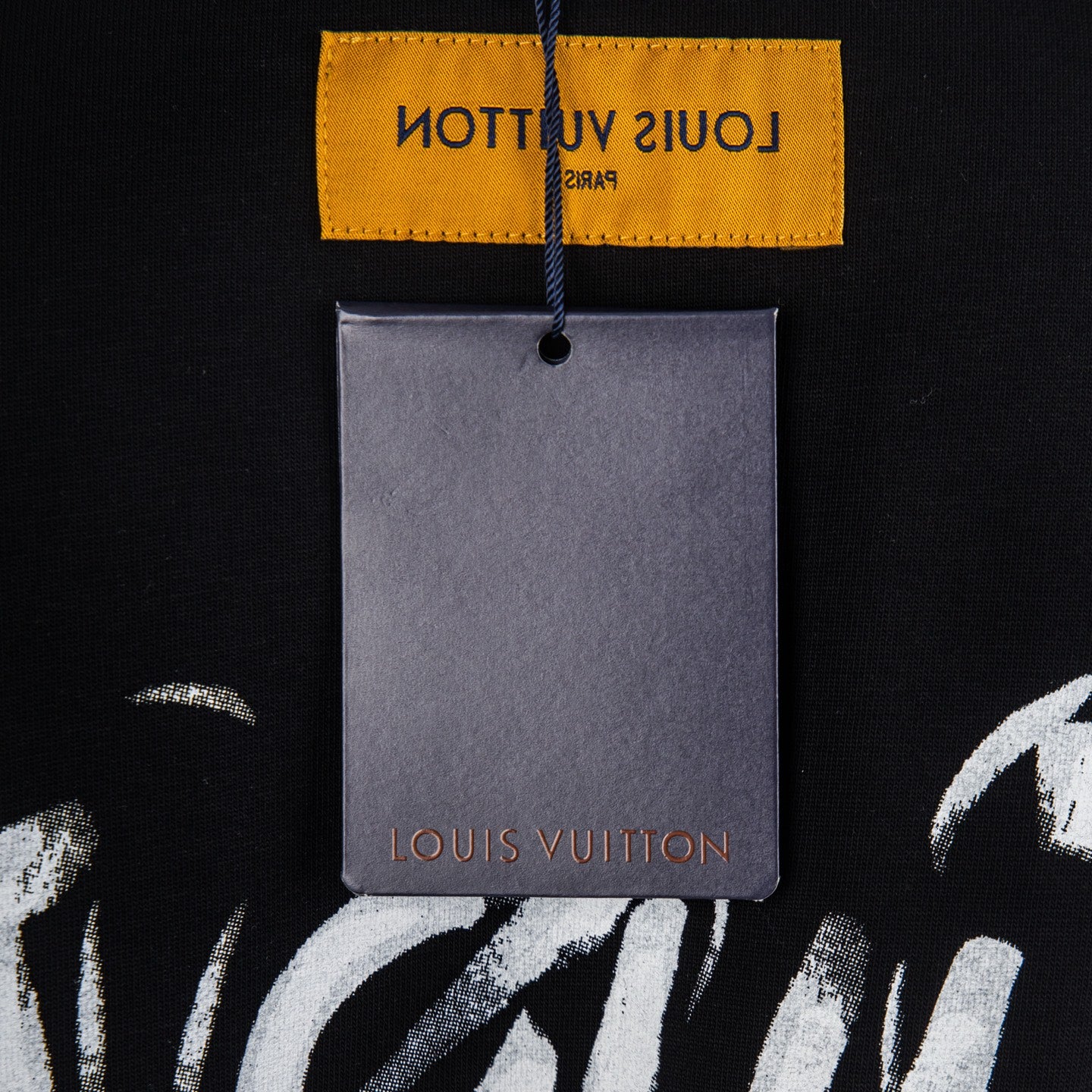 Louis Vuitton T-shirt neckline with yellow label and hanging gray brand tag