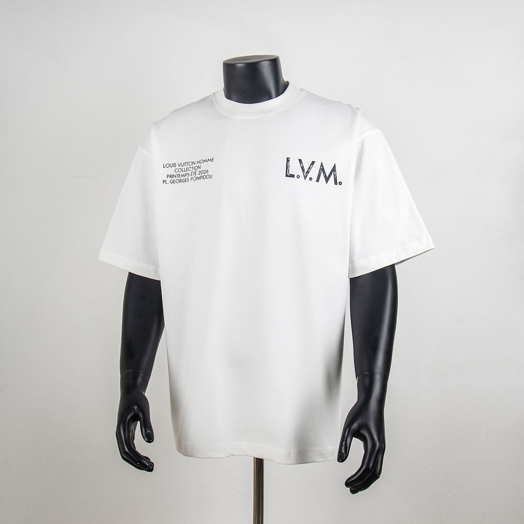 White crewneck T-shirt with 'L.V.M.' logo and small text print at chest