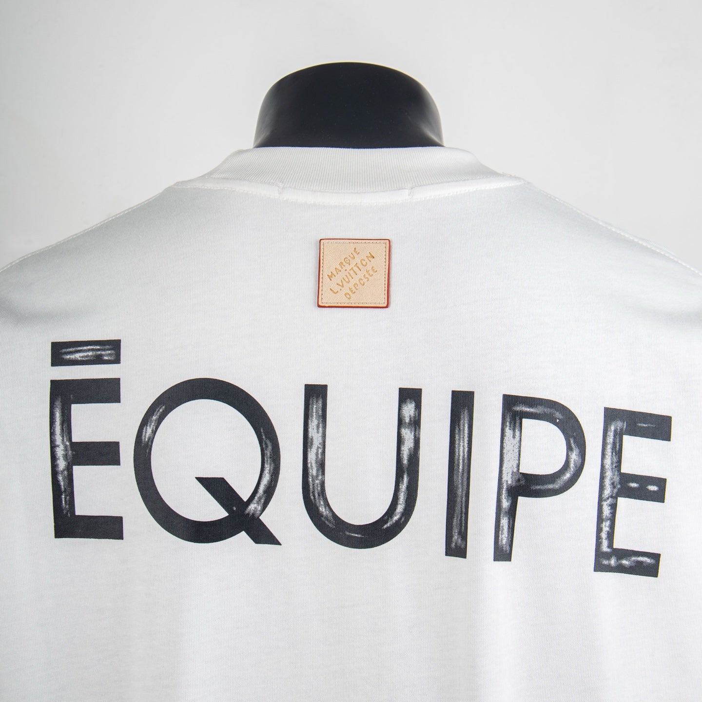 White T-shirt back with large 'EQUIPE' lettering and small logo patch