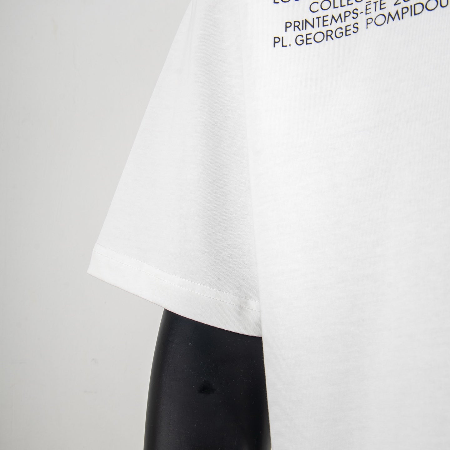 White T-shirt sleeve and hem with partial text print