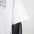 White T-shirt side view showing short sleeves and curved hem