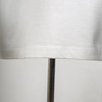 White T-shirt lower hem and visible stitching close-up