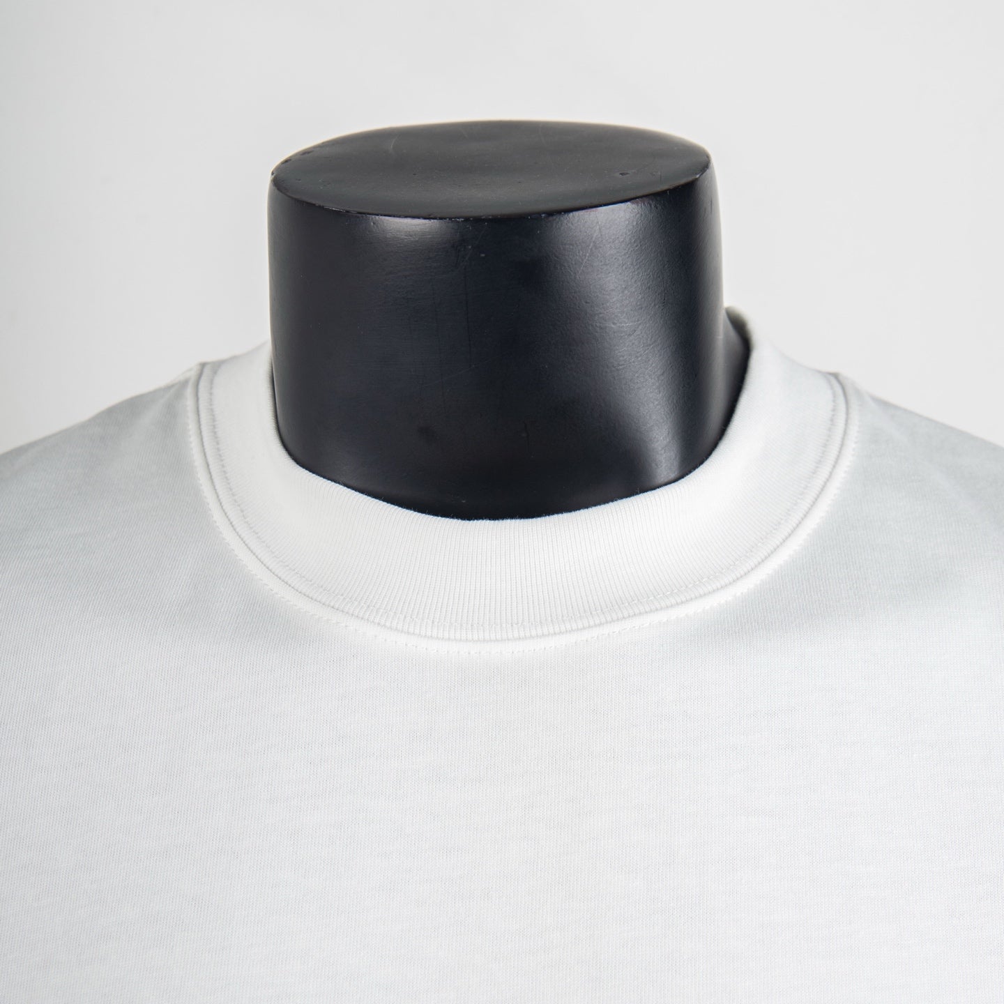 White T-shirt neckline close-up with ribbed crew collar