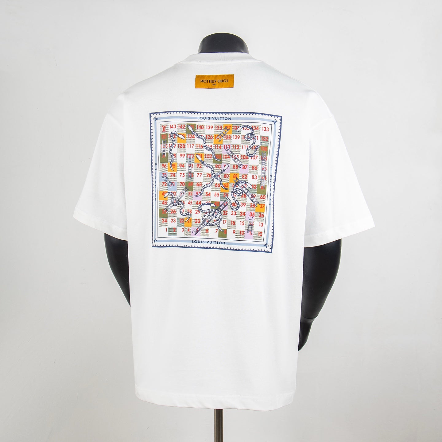 White T-shirt back with large multicolor graphic print framed with text