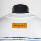 White T-shirt with orange neck label and “Louis Vuitton” text
