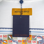 White T-shirt with hanging neck label above blue patterned trim