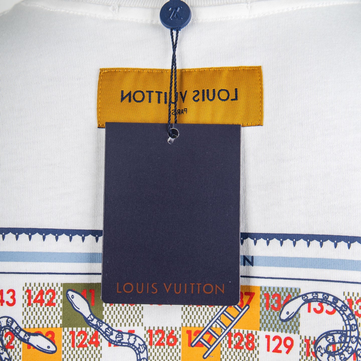 White T-shirt with hanging navy and yellow garment tag at collar