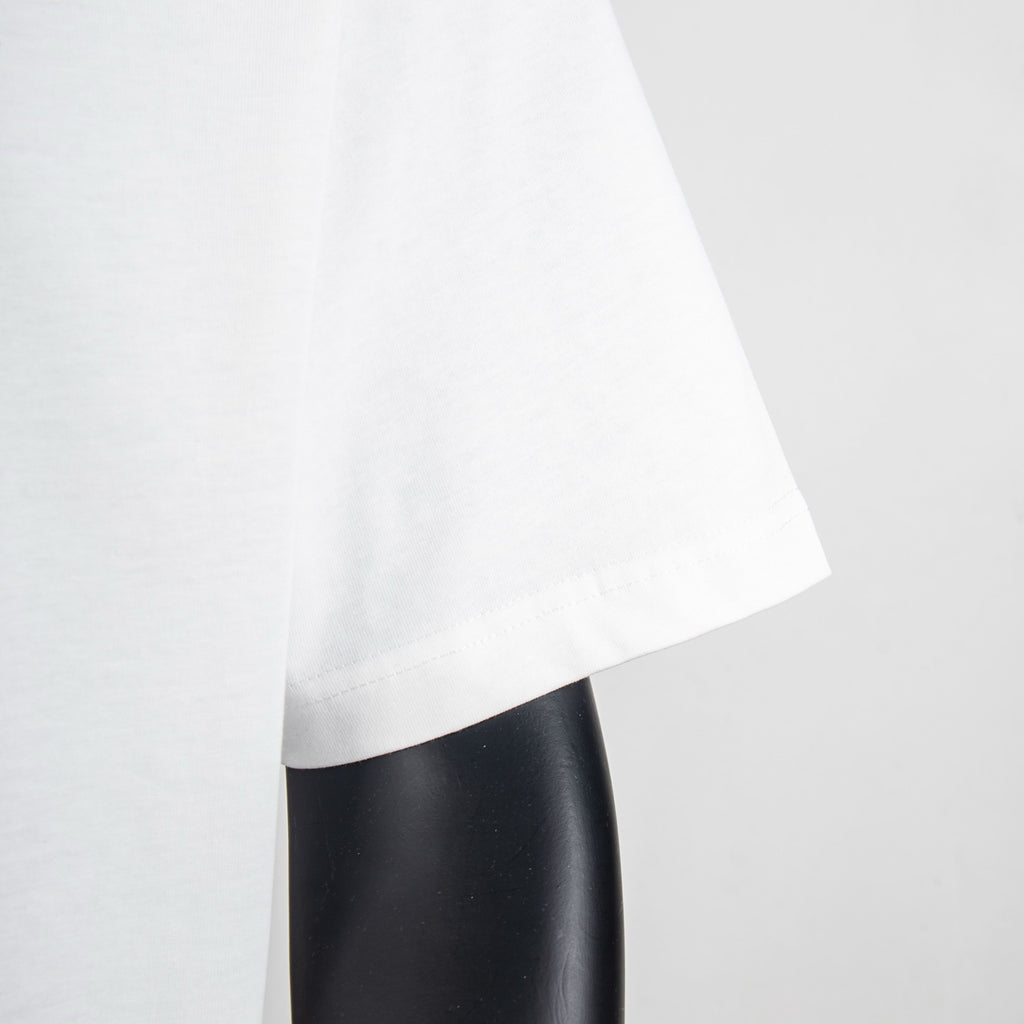 White T-shirt lower side view with curved hemline