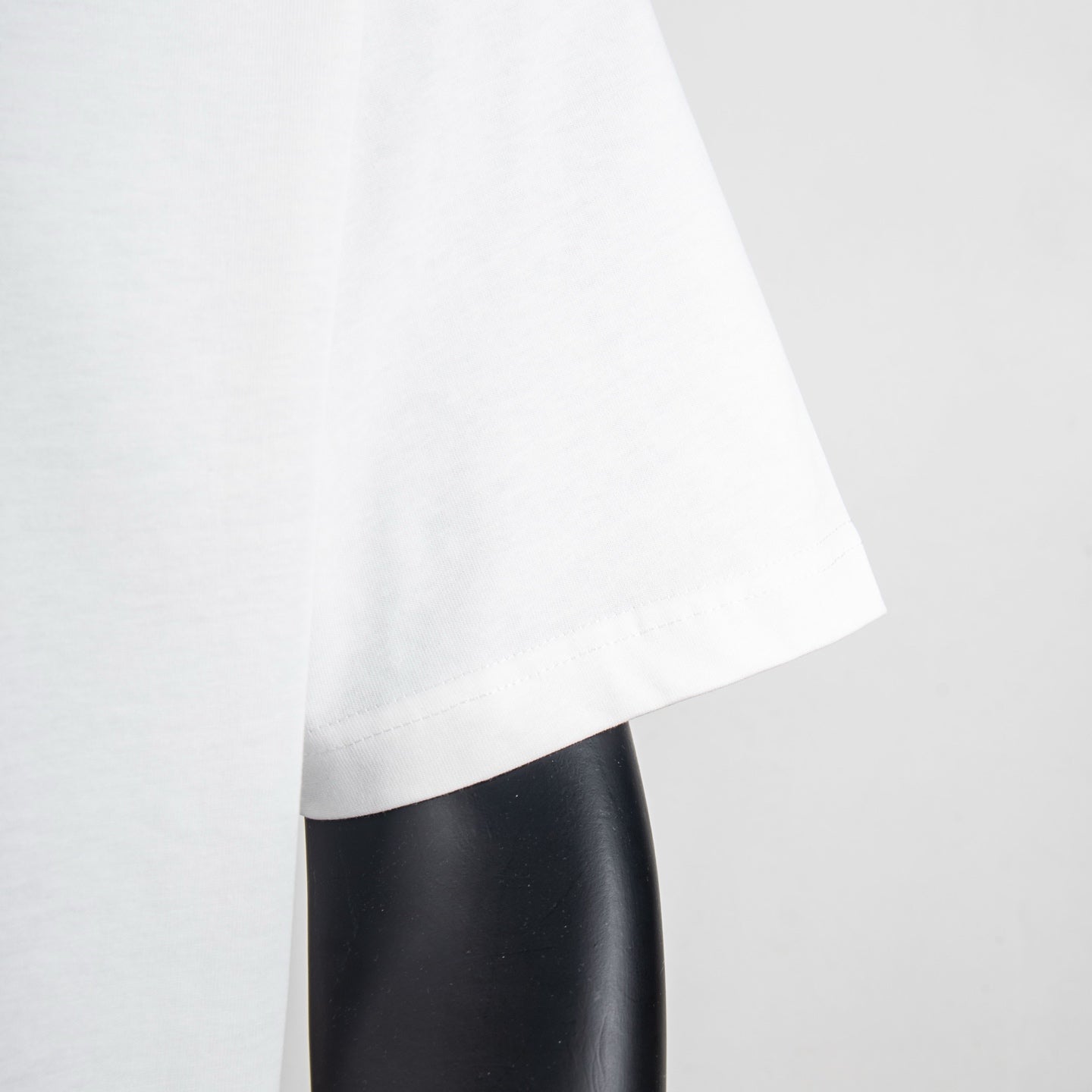 White T-shirt lower side view with curved hemline