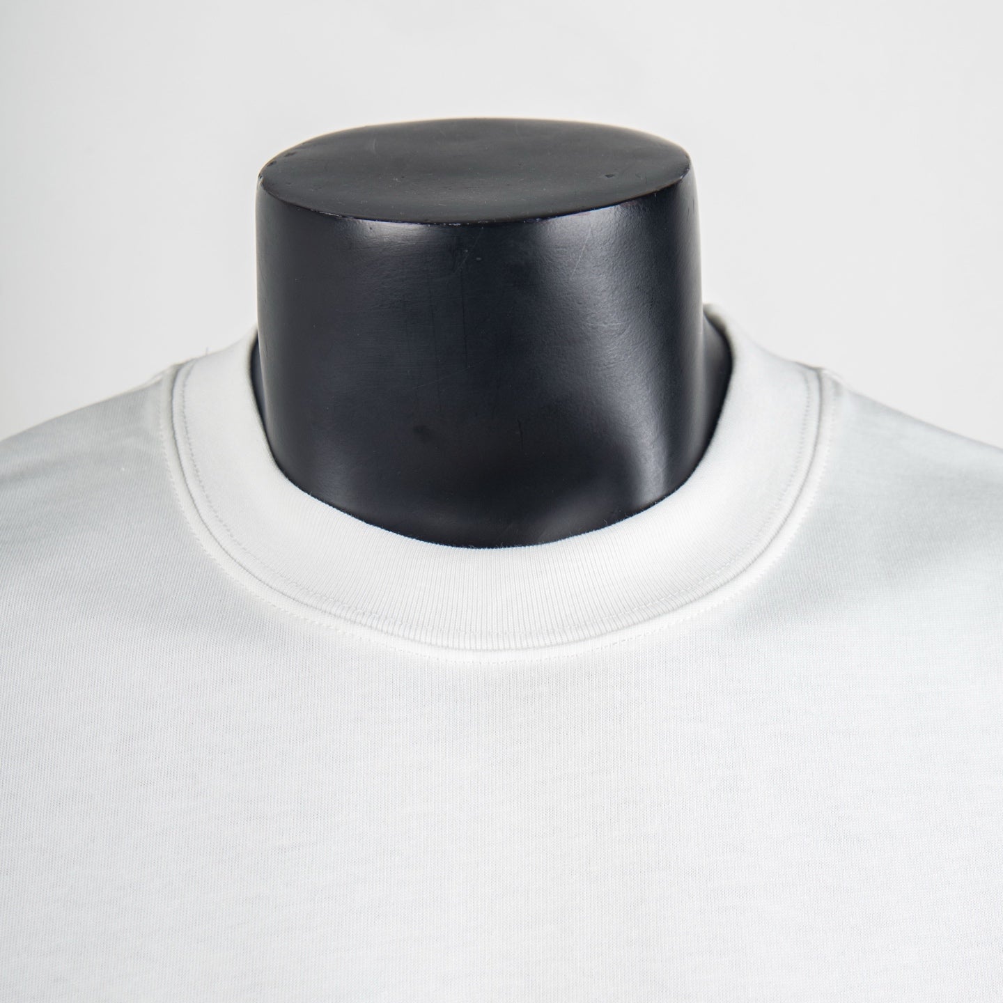 White T-shirt neckline close-up with ribbed crew collar