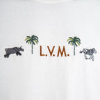 Louis Vuitton white T-shirt chest graphic with palms, zebras, and “L.V.M.” lettering