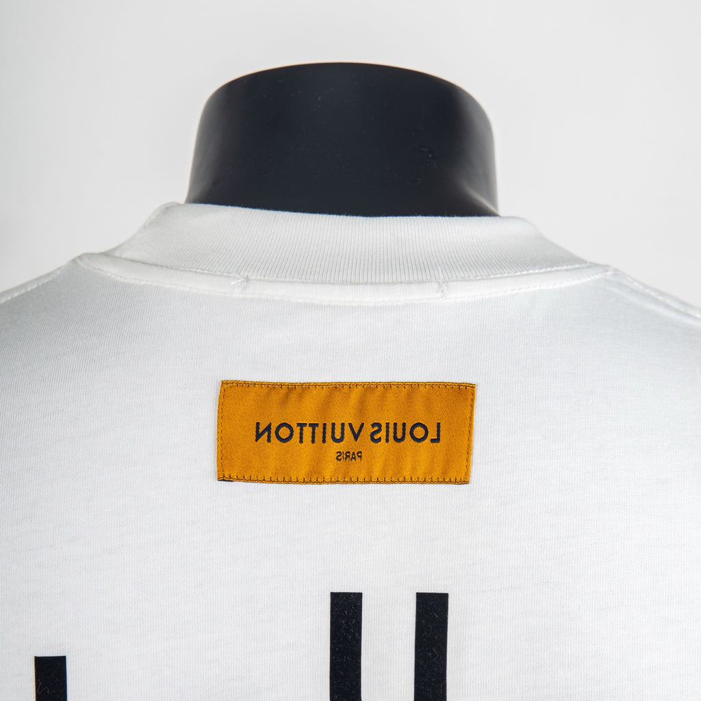White Louis Vuitton T-shirt with yellow “LOUIS VUITTON” label at back collar