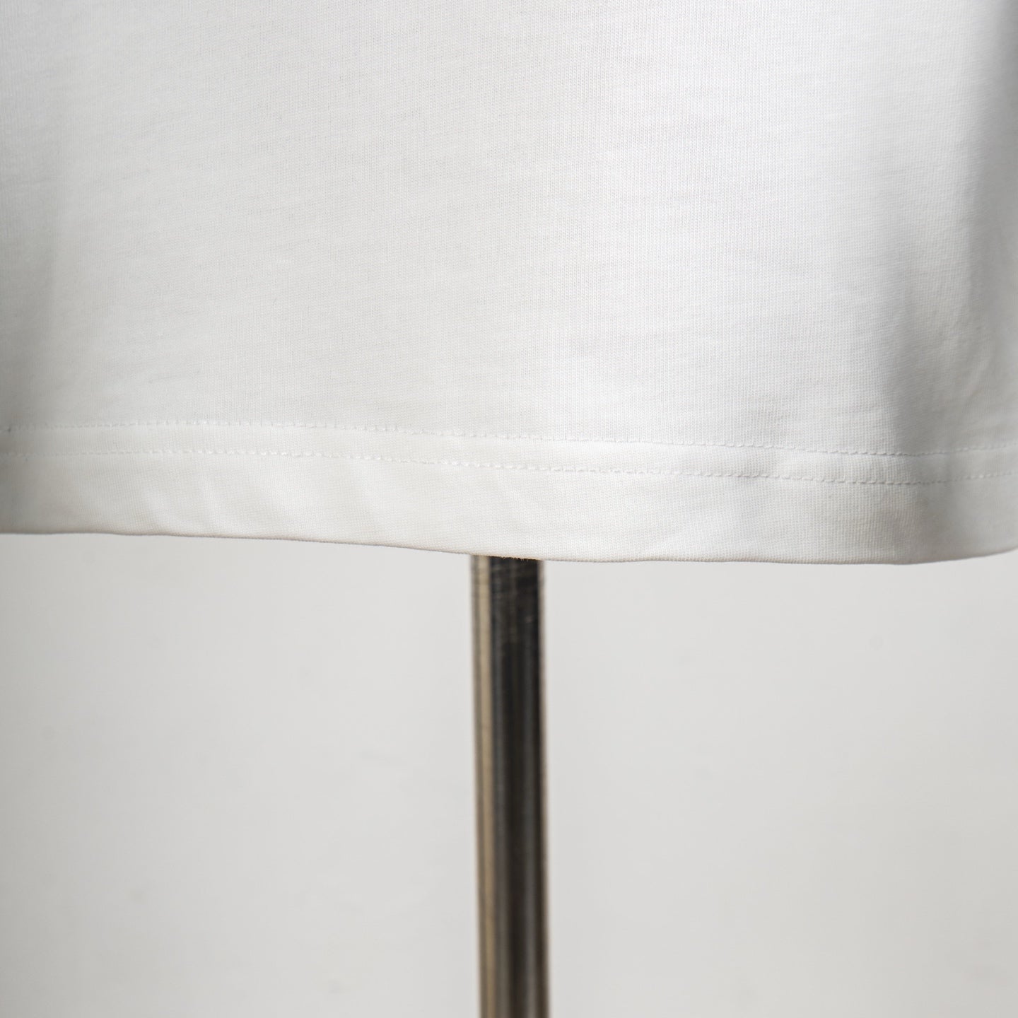 Louis Vuitton T-shirt hem close-up with clean stitched bottom edge