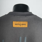 Dark gray T-shirt with yellow back neck label and stitched collar seam