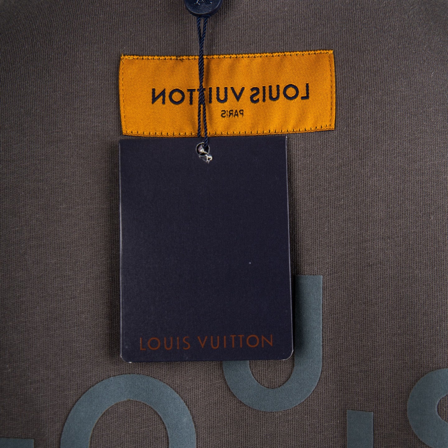 Dark gray T-shirt with yellow care label and hanging tag