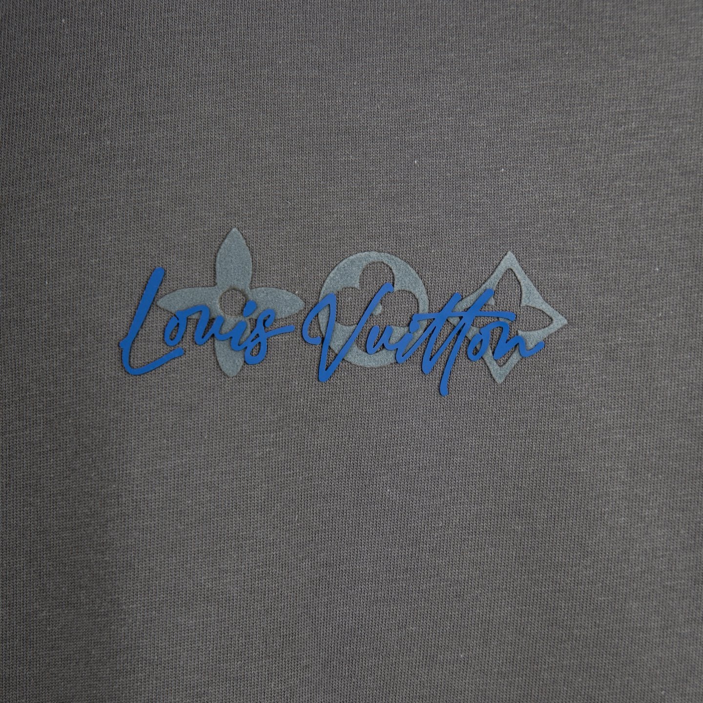 Dark gray T-shirt with blue script logo across the chest