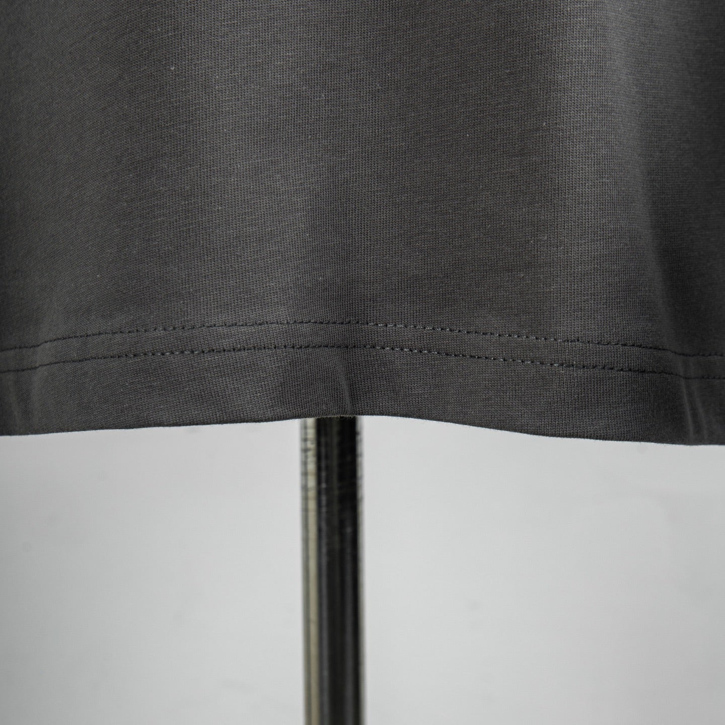 Dark gray T-shirt hem stitching close-up