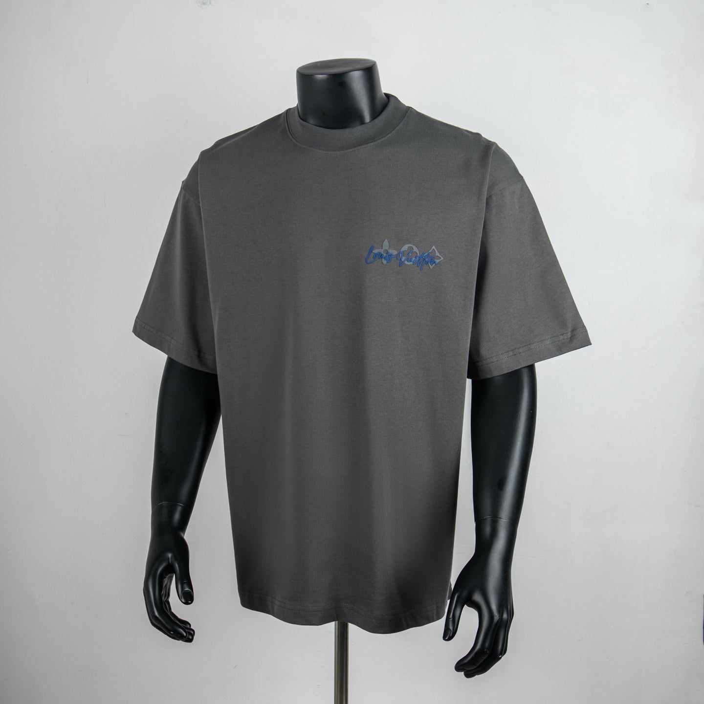Dark gray short-sleeve T-shirt with small blue chest logo