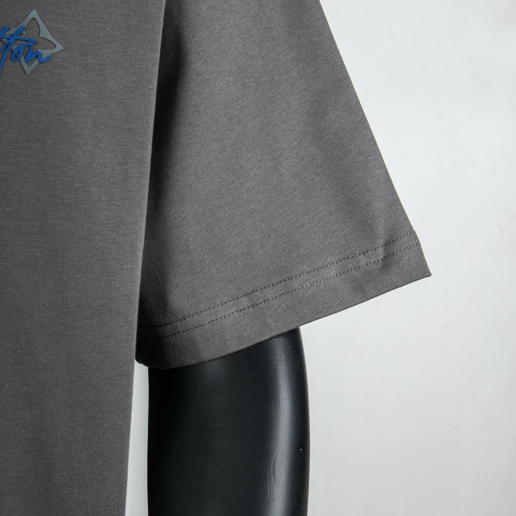 Louis Vuitton short-sleeve t-shirt side view with curved hem on dark gray
