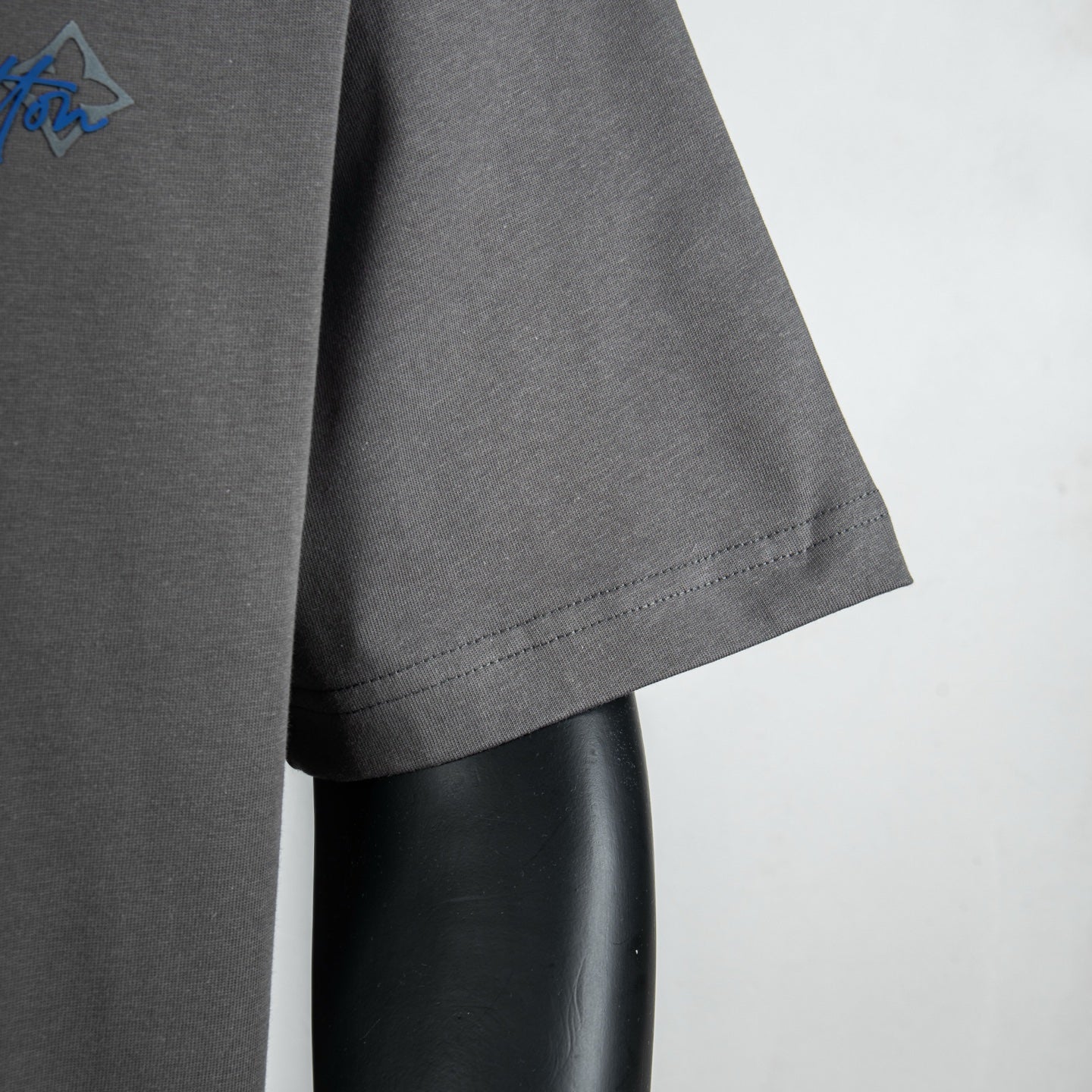 Louis Vuitton short-sleeve t-shirt side view with curved hem on dark gray
