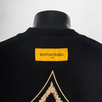 Louis Vuitton T-shirt back neckline with yellow brand label and gold diamond emblem