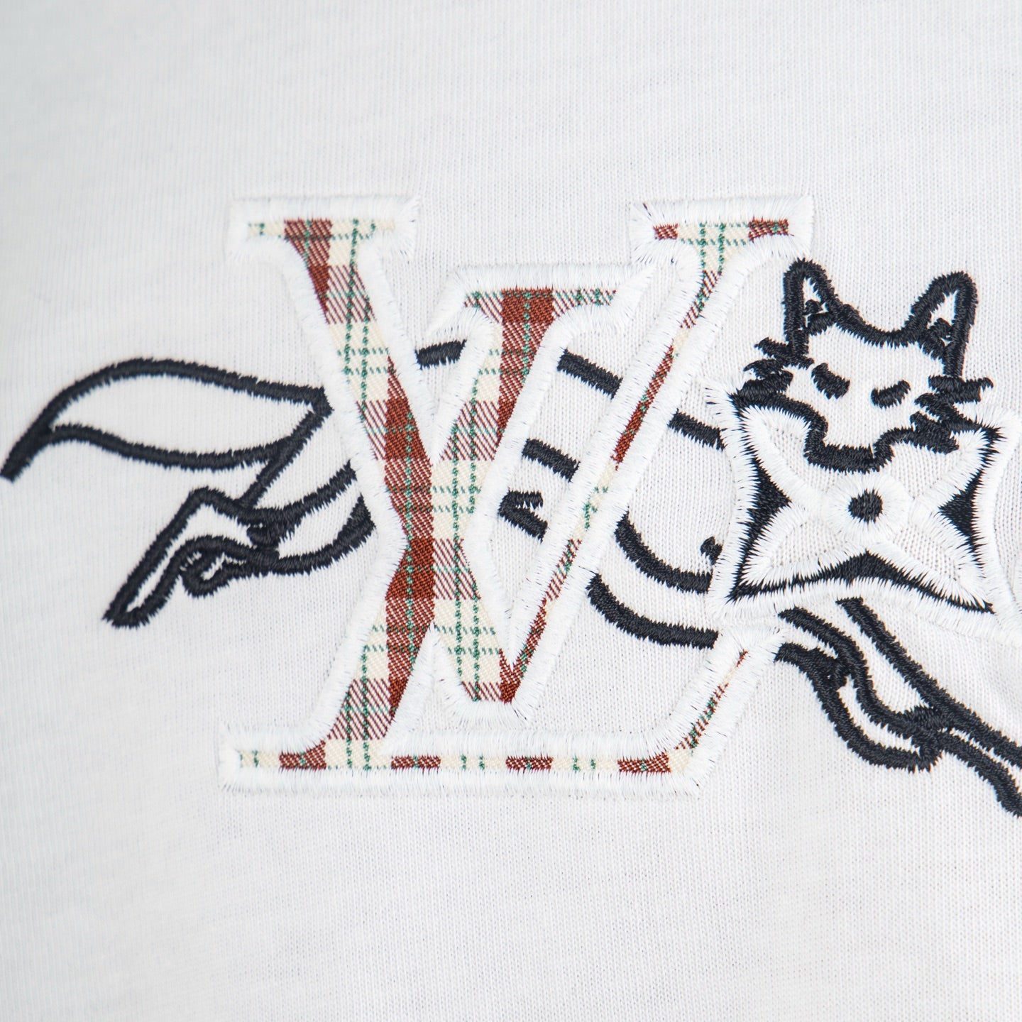 White T-shirt front close-up of 'LV' graphic and animal figure