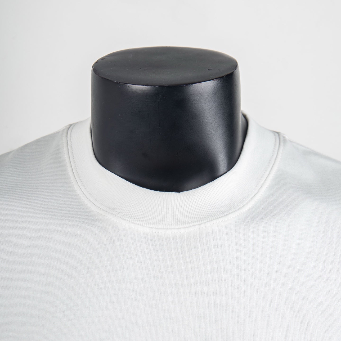 White short-sleeve T-shirt neckline close-up with ribbed crew collar