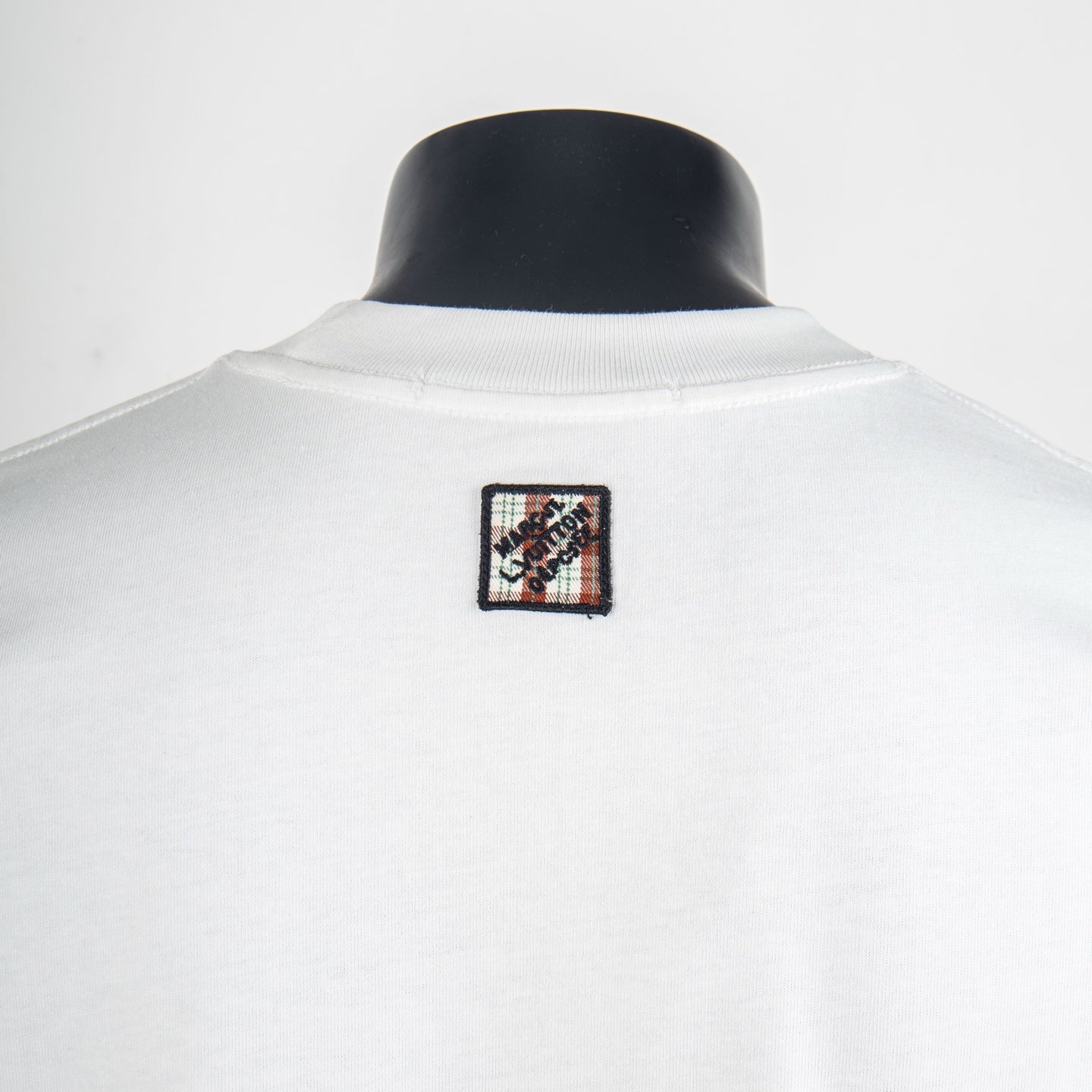 White short-sleeve T-shirt, back view with multicolor square logo patch at center neck