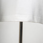 White T-shirt hem stitching close-up along the bottom edge
