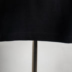 Black T-shirt hem with visible stitching detail