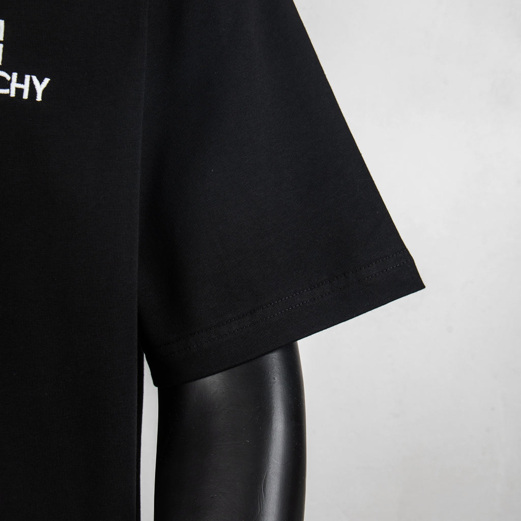 Black T-shirt sleeve and hem close-up with neat stitching