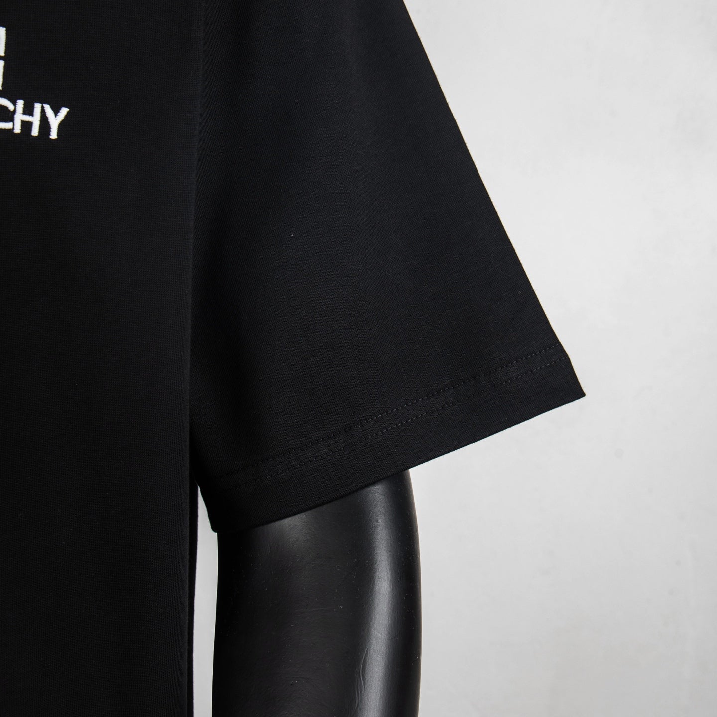 Black T-shirt sleeve hem with stitched cuff detail