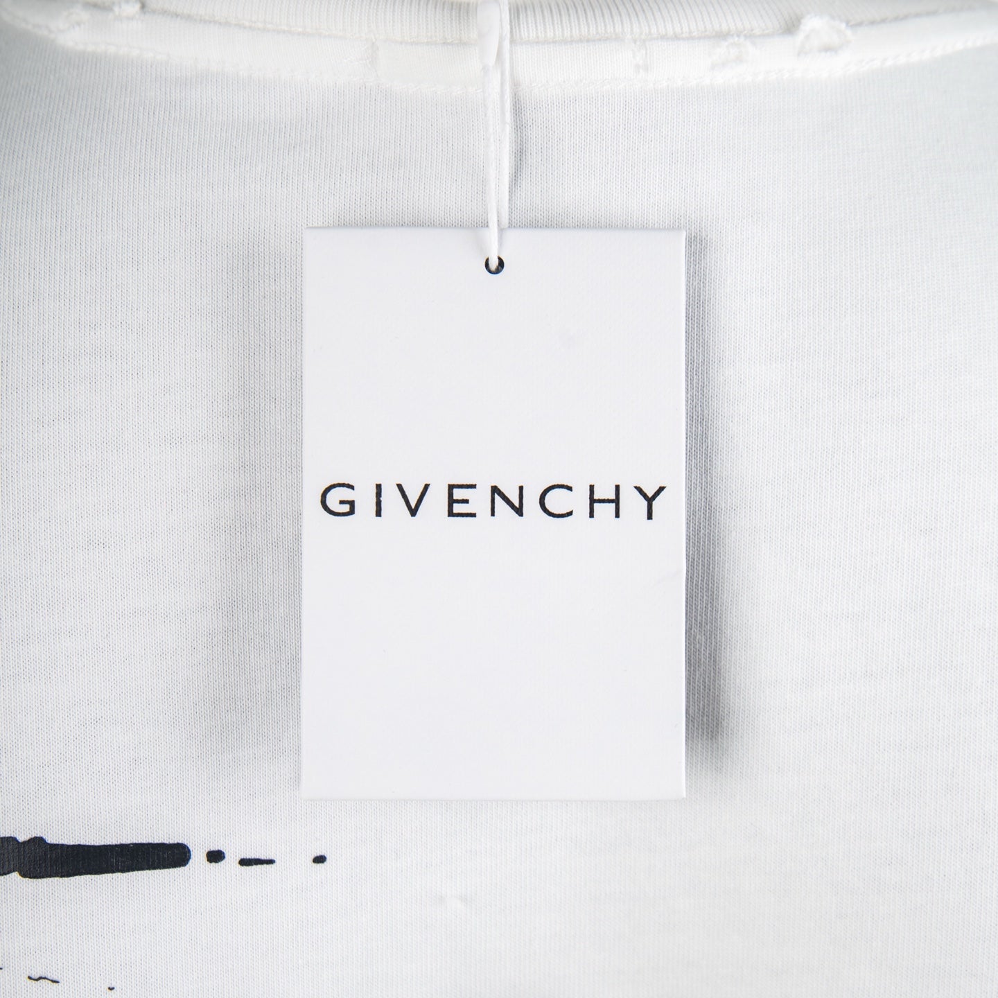 White T-shirt with hanging brand tag labeled GIVENCHY