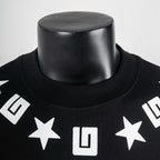 Black crewneck T-shirt with white star and geometric logo print on chest