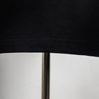 Black T-shirt hem with stitched edge detail