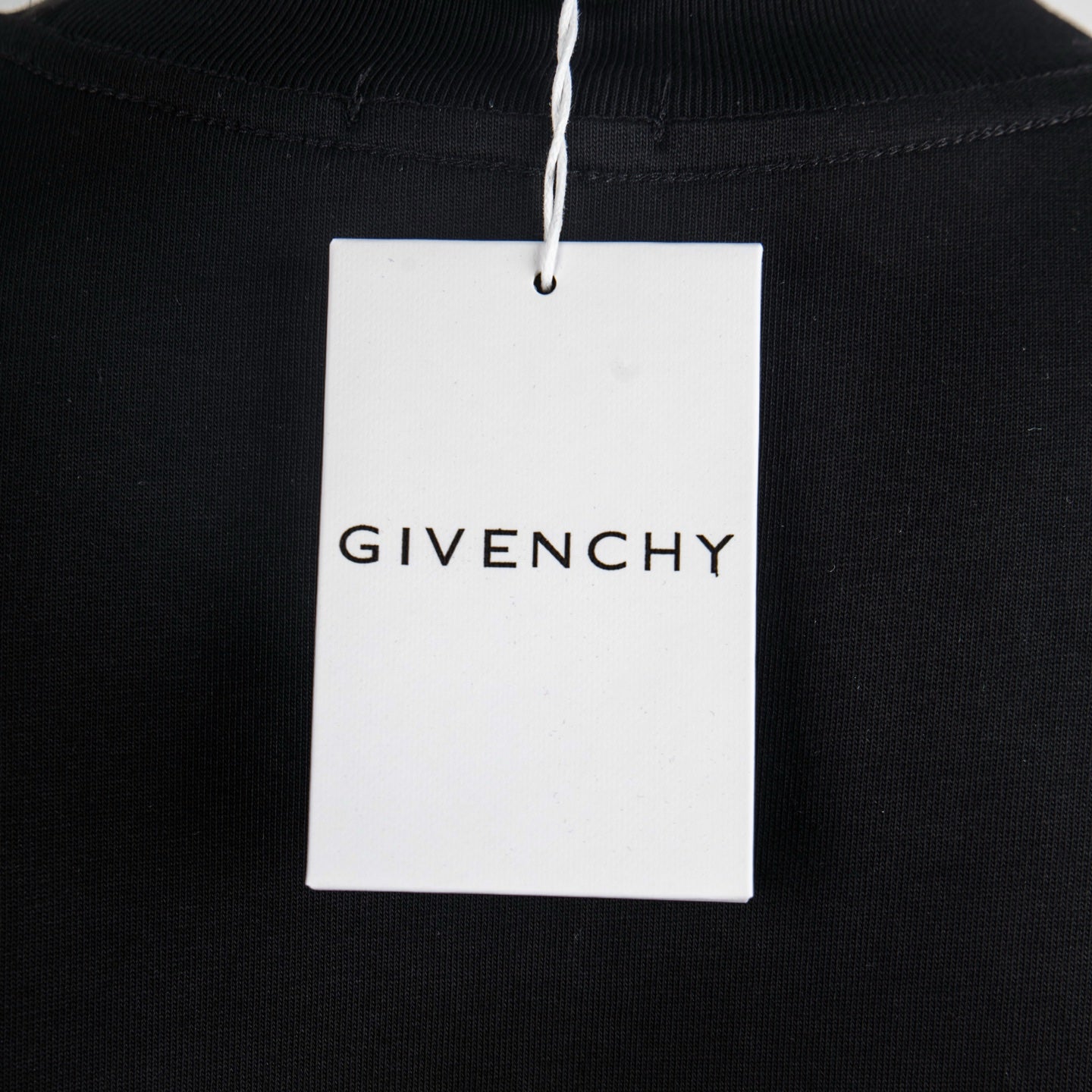 Black T-shirt with hanging GIVENCHY brand label
