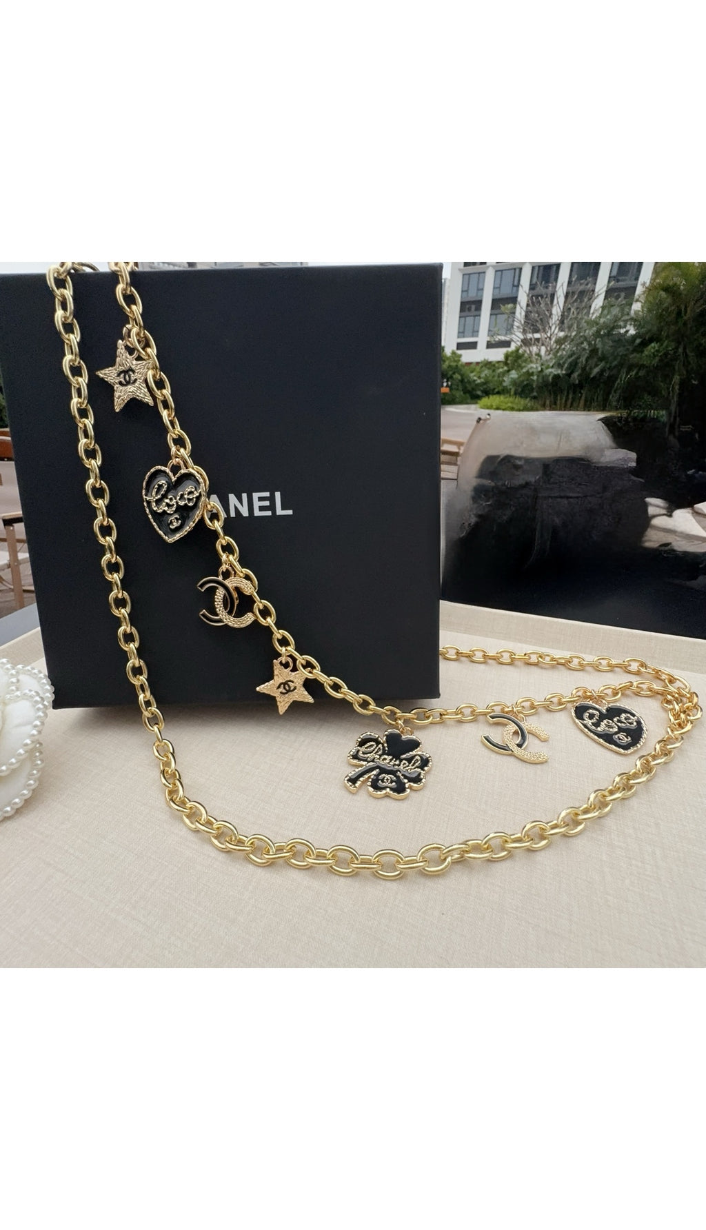 Gold-tone chain belt with CC logos, star charms, and dangling heart pendants