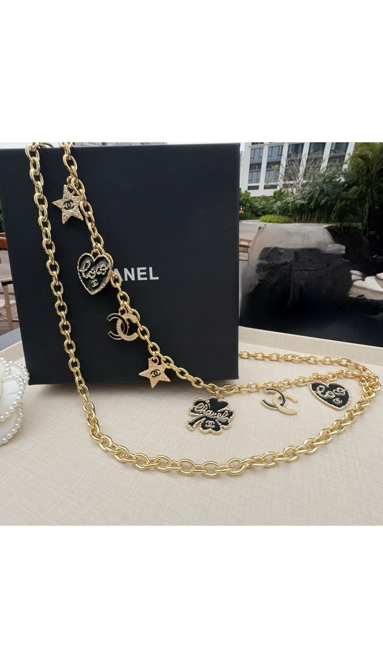 Gold-tone chain belt with CC logos, star charms, and dangling heart pendants