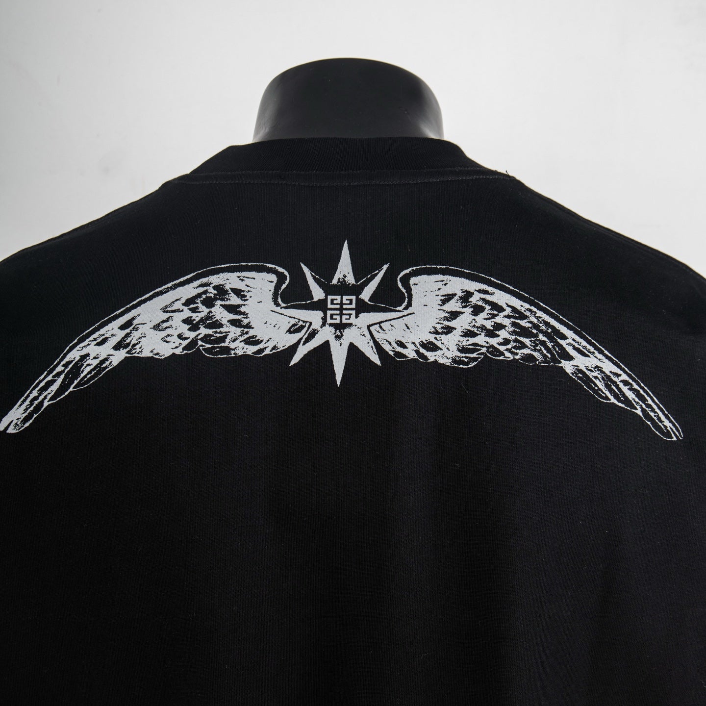 Givenchy black T-shirt with large wing graphic and crown emblem on back.