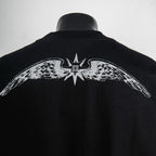 Back of black T-shirt with white winged emblem and central star